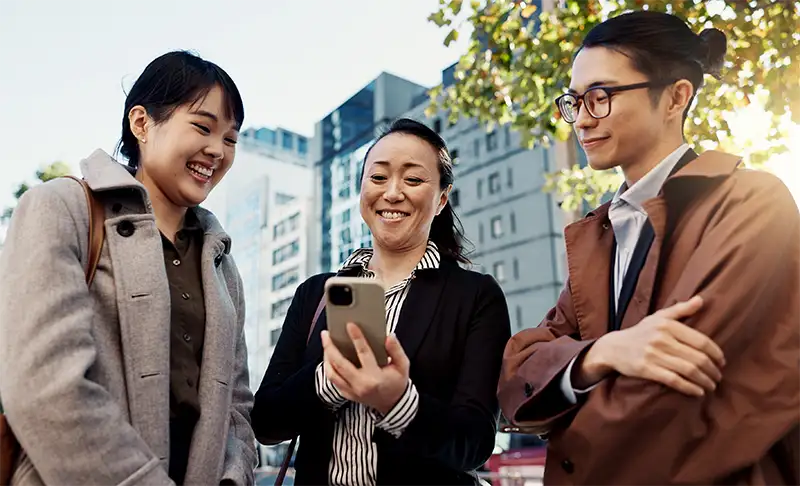 group of perople looking at phone